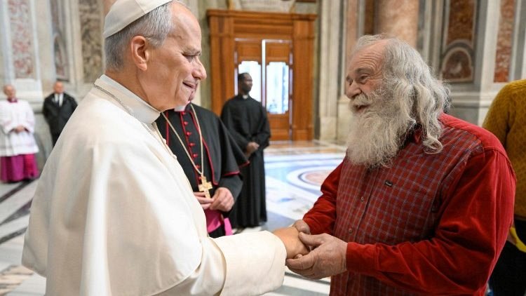 Pope Leo greets a man attending the Mass (@Vatican Media)